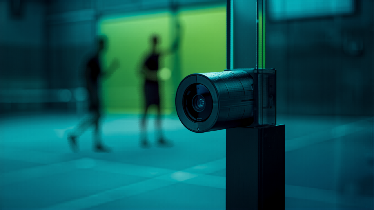 Close-up of a sleek RacketCam AI sports camera mounted on a padel court glass post